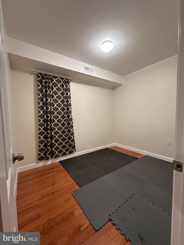 workout area with hardwood / wood-style floors