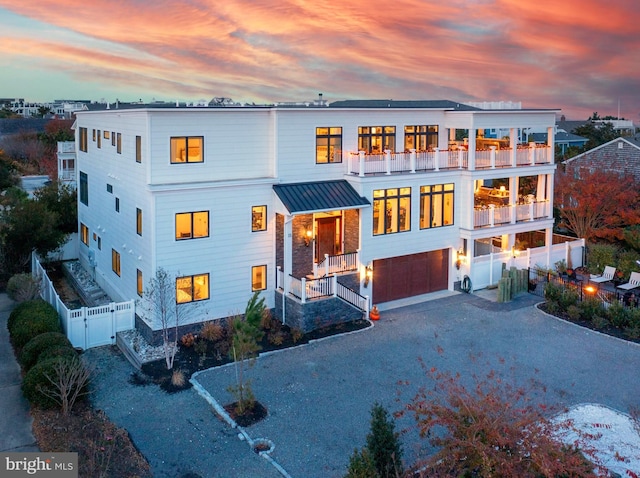 exterior space with a garage and a balcony