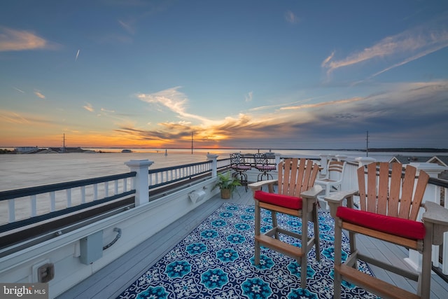 exterior space featuring a balcony and a water view