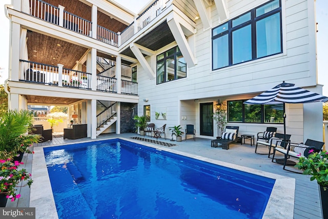 view of swimming pool with outdoor lounge area and a patio area