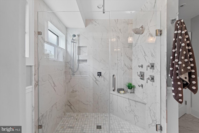 bathroom featuring a shower with shower door