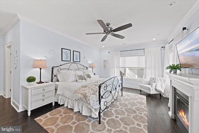 bedroom with crown molding, dark hardwood / wood-style floors, and ceiling fan