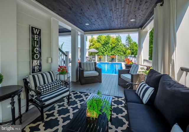 exterior space with an outdoor living space and a fenced in pool