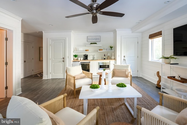 living room with crown molding, sink, dark hardwood / wood-style floors, and ceiling fan