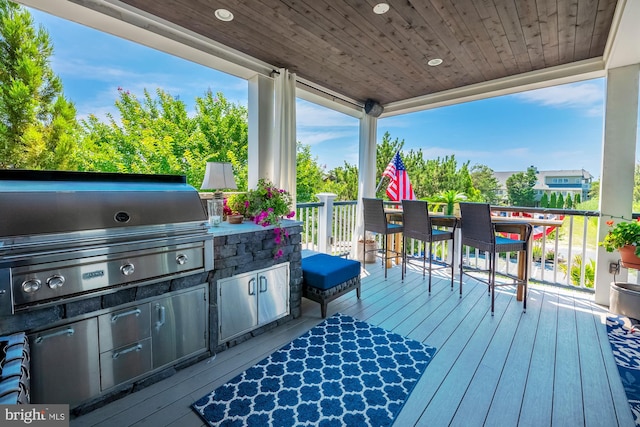 deck with a grill and area for grilling