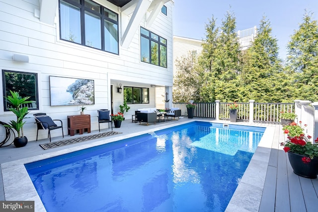 view of pool featuring outdoor lounge area and a patio