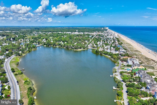 birds eye view of property with a beach view and a water view