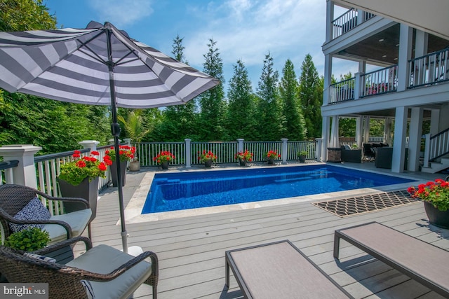 view of swimming pool with a wooden deck