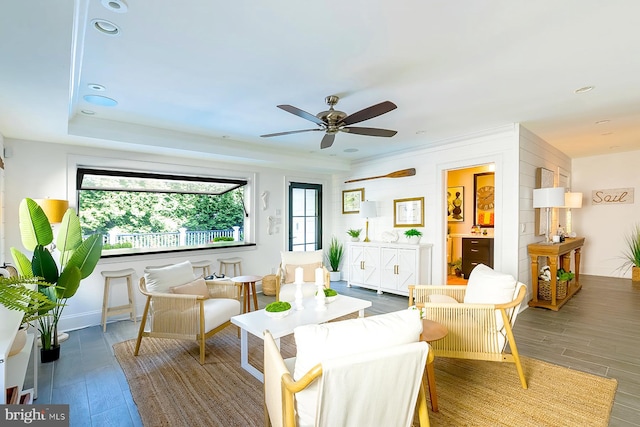 living room featuring ceiling fan and wood-type flooring