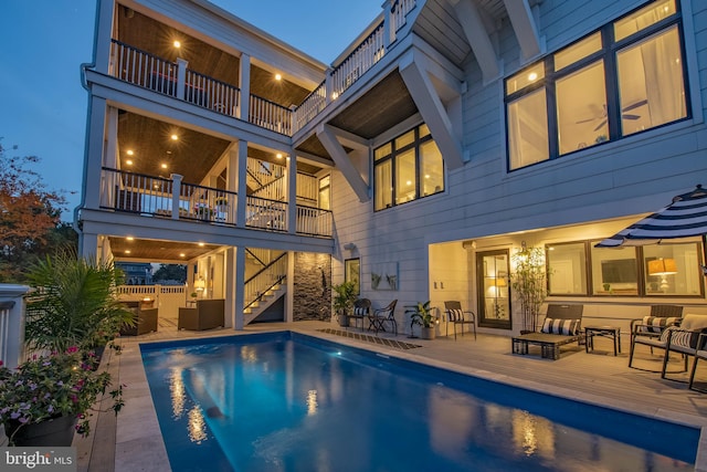 back of property with outdoor lounge area and a balcony