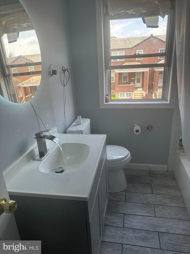 full bathroom featuring vanity, toilet, and shower / bath combo with shower curtain