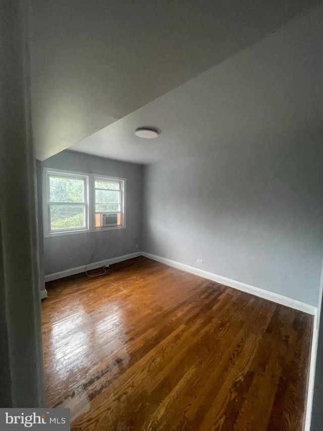 empty room with dark hardwood / wood-style flooring