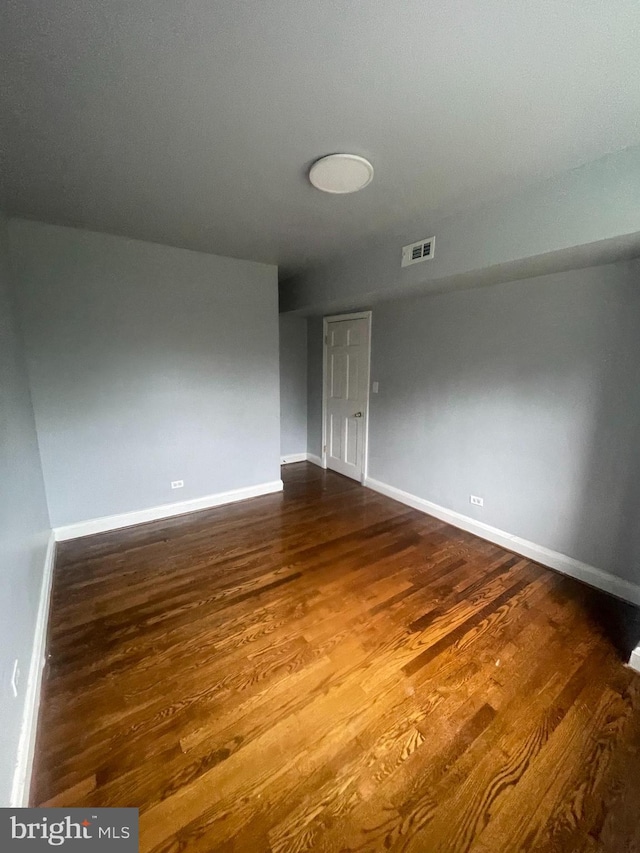 spare room featuring dark wood-type flooring