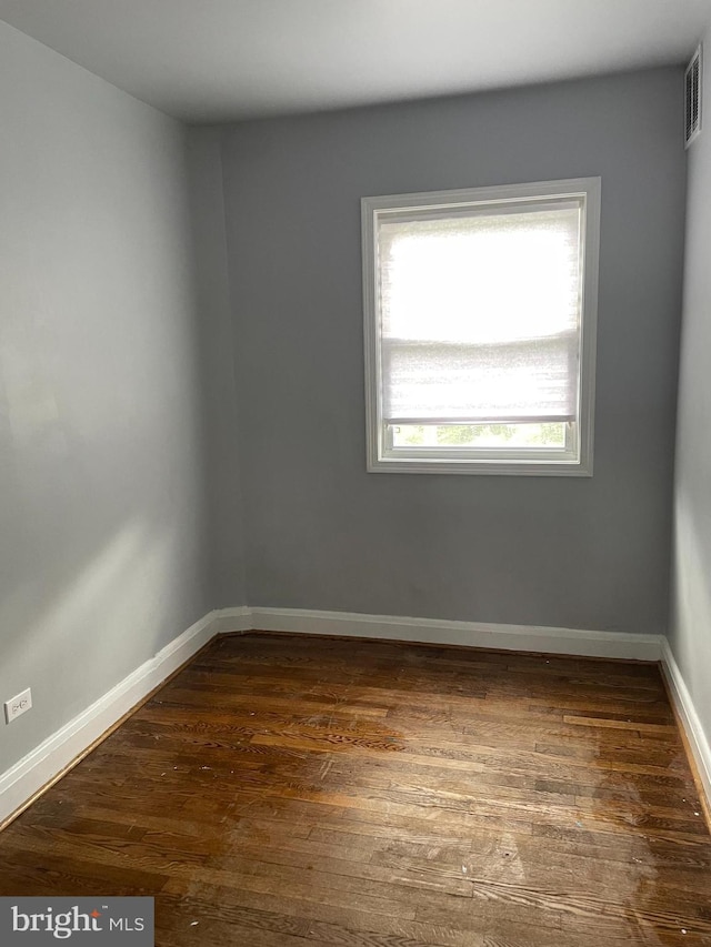 spare room with dark hardwood / wood-style flooring