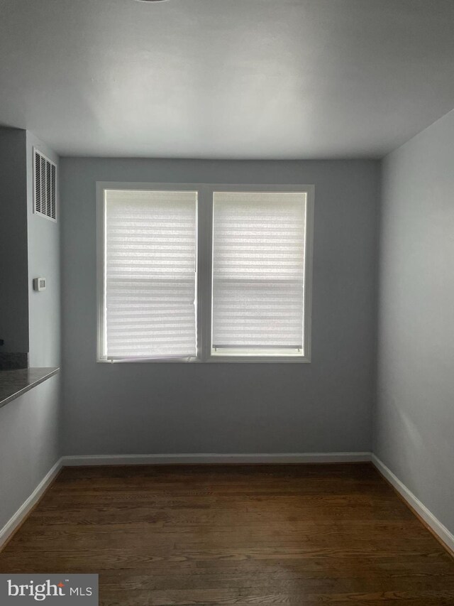 spare room with dark hardwood / wood-style flooring