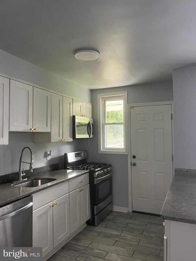 kitchen with white cabinetry, appliances with stainless steel finishes, and sink