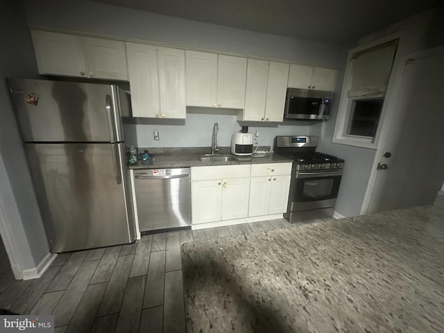 kitchen featuring white cabinetry, sink, dark hardwood / wood-style floors, and appliances with stainless steel finishes