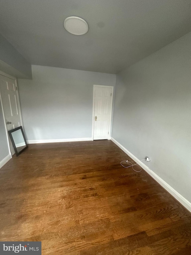 spare room featuring dark hardwood / wood-style floors