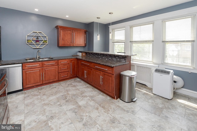 kitchen featuring stainless steel dishwasher, hanging light fixtures, light tile flooring, and dark stone counters