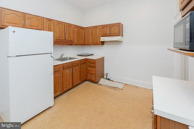 kitchen with sink and white refrigerator