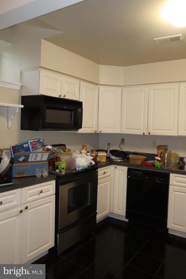 kitchen featuring black appliances, white cabinets, and dark tile flooring