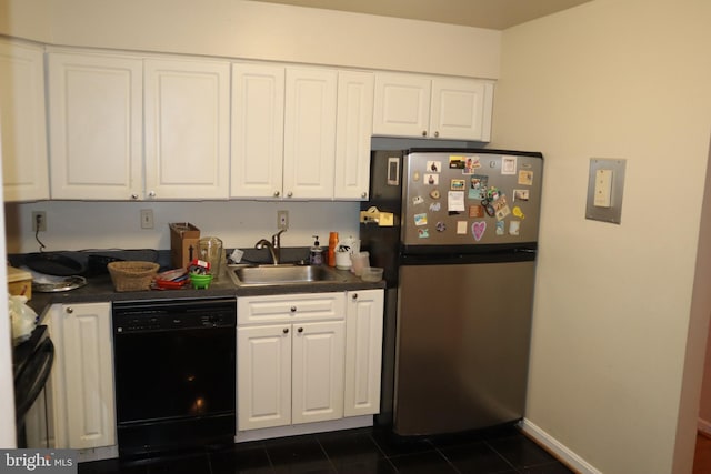 kitchen with white cabinets, stainless steel refrigerator, sink, dark tile flooring, and dishwasher