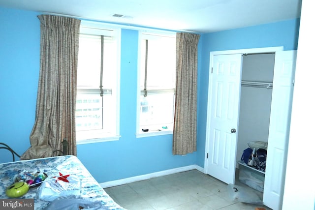 tiled bedroom featuring a closet