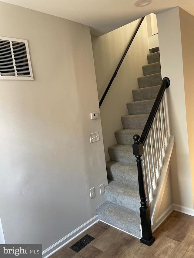 staircase featuring hardwood / wood-style floors