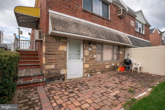 rear view of house featuring a patio and a wall mounted air conditioner