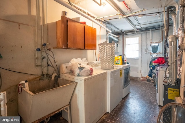 laundry area with independent washer and dryer and sink