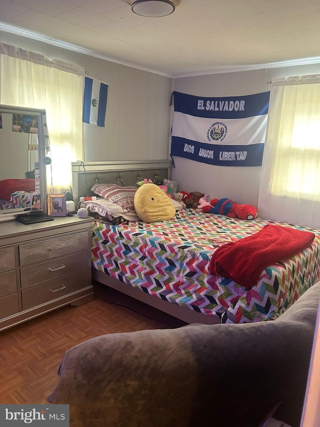 bedroom featuring ornamental molding and dark parquet floors