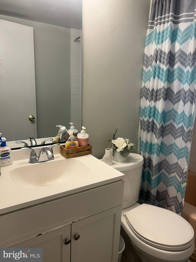 bathroom with large vanity and toilet