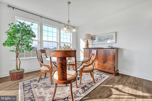 dining area featuring dark hardwood / wood-style floors and a notable chandelier