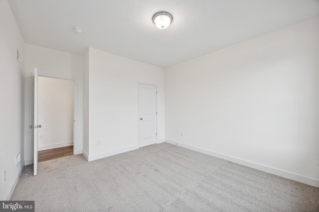 unfurnished bedroom featuring light colored carpet