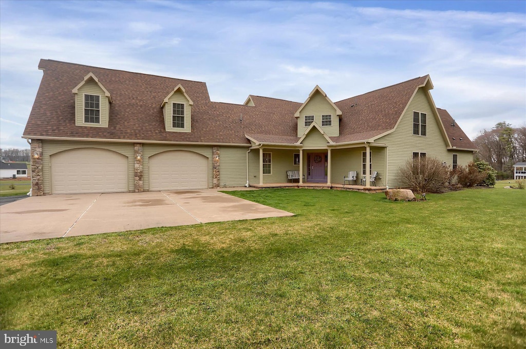 new england style home featuring a garage and a front yard