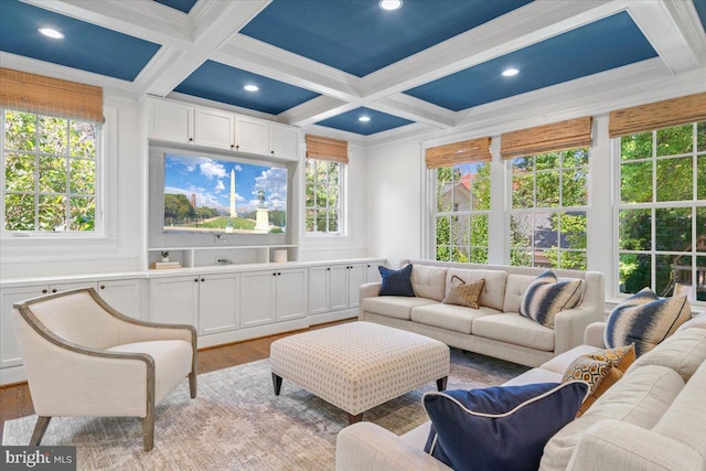 living room with light wood-type flooring, coffered ceiling, and a healthy amount of sunlight