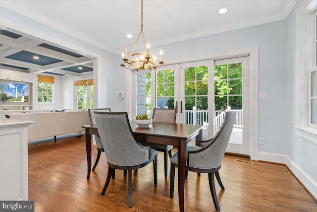 dining space with crown molding, coffered ceiling, wood-type flooring, and a chandelier