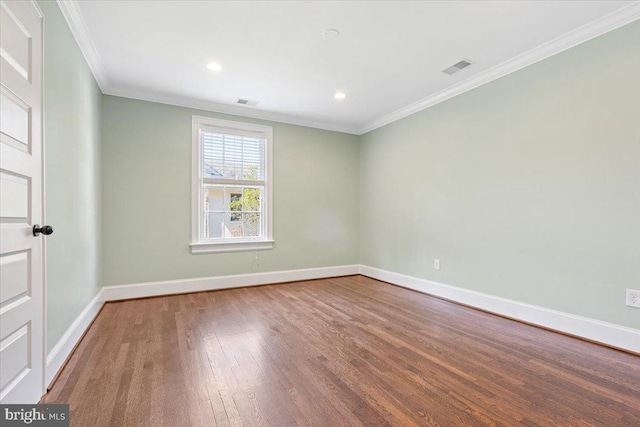 spare room with hardwood / wood-style flooring and ornamental molding