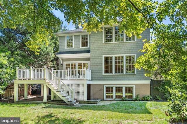 rear view of house featuring a yard and a deck