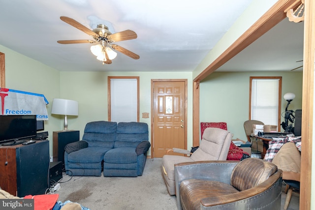 carpeted living room featuring ceiling fan