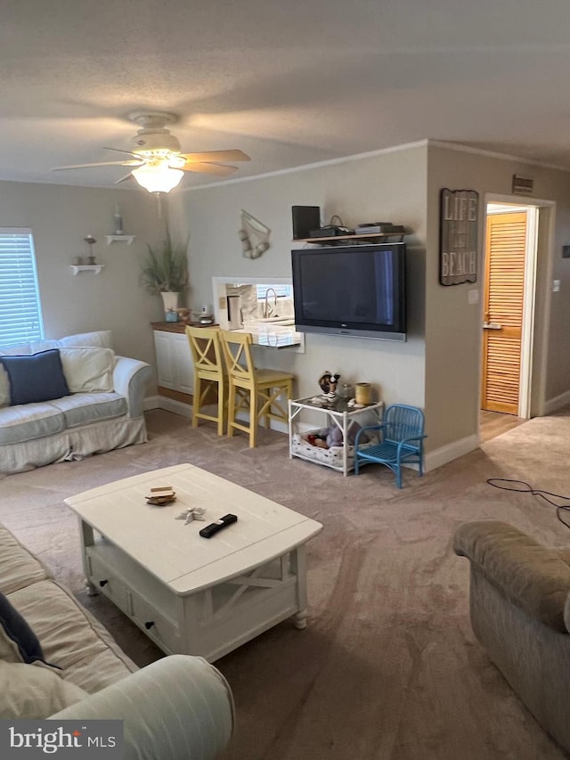 carpeted living room with ceiling fan