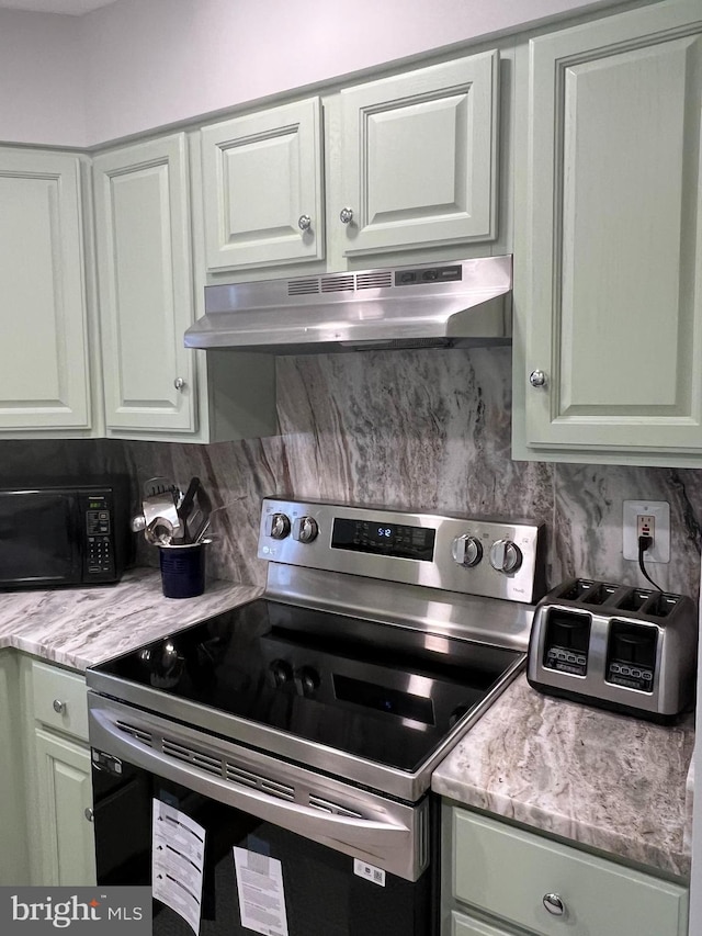 kitchen with electric range, light stone countertops, backsplash, and wall chimney exhaust hood