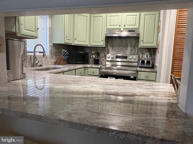 kitchen featuring fume extractor, tasteful backsplash, green cabinets, and stainless steel electric range