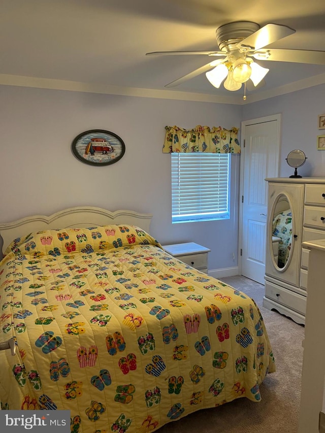 bedroom featuring crown molding, light carpet, and ceiling fan