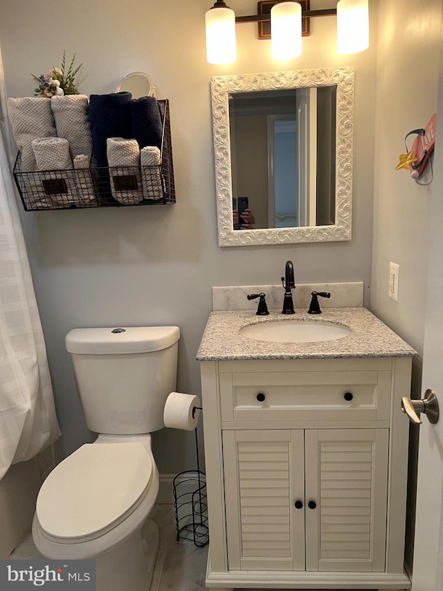 bathroom with vanity and toilet