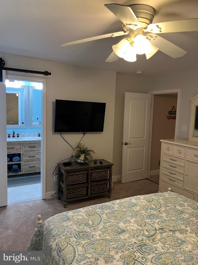 bedroom featuring connected bathroom, ceiling fan, sink, and carpet floors