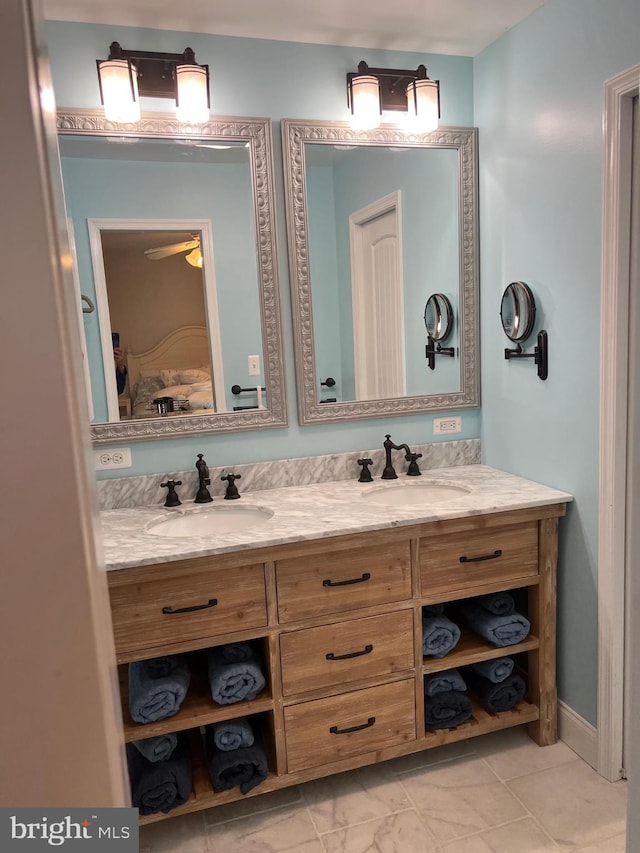 bathroom with tile floors, ceiling fan, and double sink vanity