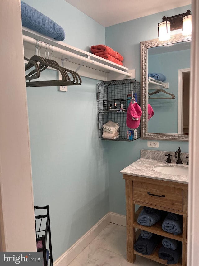 spacious closet with sink and tile flooring