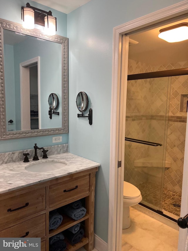 bathroom featuring an enclosed shower, vanity, toilet, and tile flooring