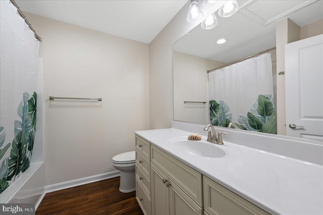 full bathroom with hardwood / wood-style flooring, shower / tub combo, toilet, and oversized vanity